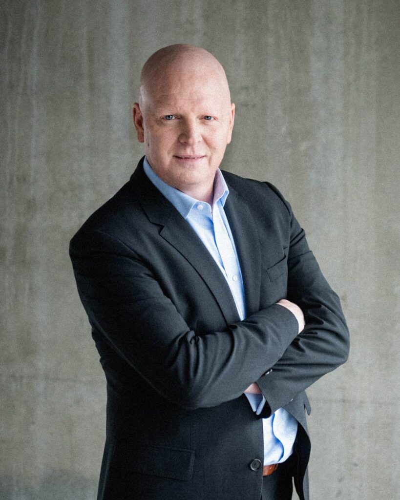 image of shawn wentworth standing next to concrete wall