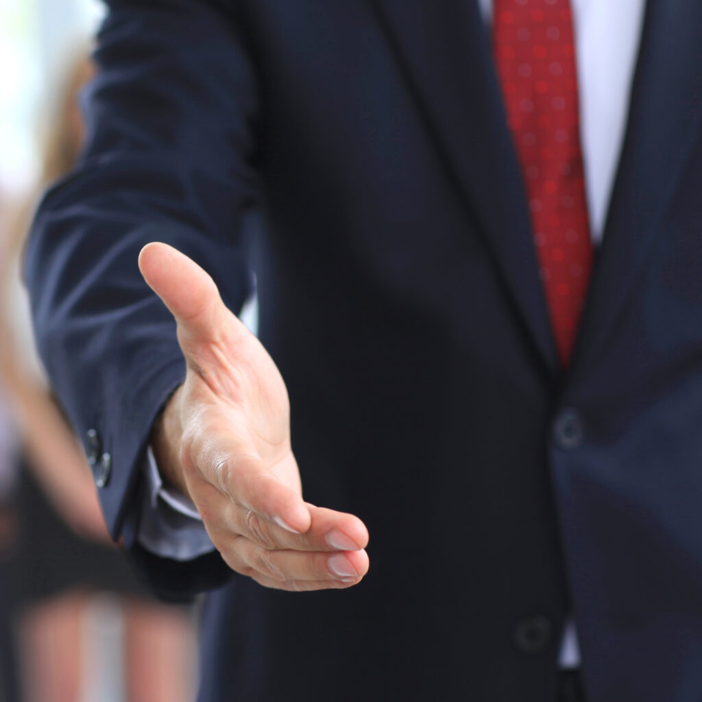 A business man with an open hand ready to seal a deal